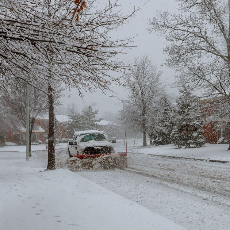 Truck plowing snow in a street